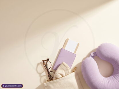 Blank boarding pass in a lavender passport cover beside glasses and neck pillow for a turkey flight hair transplant trip